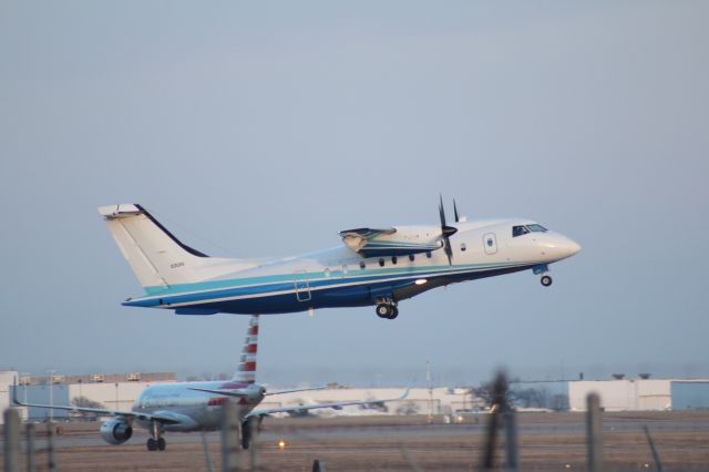 Fairchild Dornier 328 (10-3026) - 022414 USAF SOCOM C146 rotating from Rwy 19R. Inbound AA A319 taxiing.