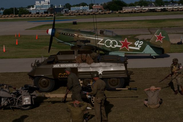 YAKOVLEV Yak-9 (N1157H) - N1157H taxis behind the WWII reenactors at OSH09.