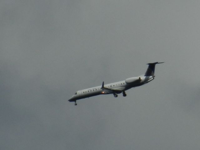 Embraer ERJ-145 (N11193) - A United Express Embraer E-145 Dips The Wing At The Camera While Turning Into Dulles Int With Landing Gear Down