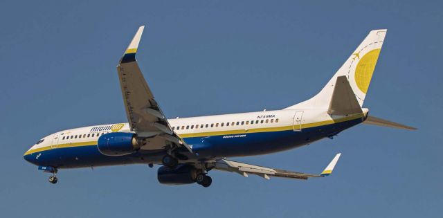 Boeing 737-800 (N749MA) - Miami Air Internationals "Sheila," a B738 (N749MA), is captured in this photo taken three hours ago as it is on final to land at Reno Tahoe International to complete a flight from Cherry Point (KNKT).  When "Sheila" parked at Atlantic Aviation, the planeload full of United States Marines emerged into the air temperature of 99 degrees F and an on-the-ramp temperature over 110 degrees F.  It is summertime here in northern Nevada.br /* Suggest selecting FULL for best Q.