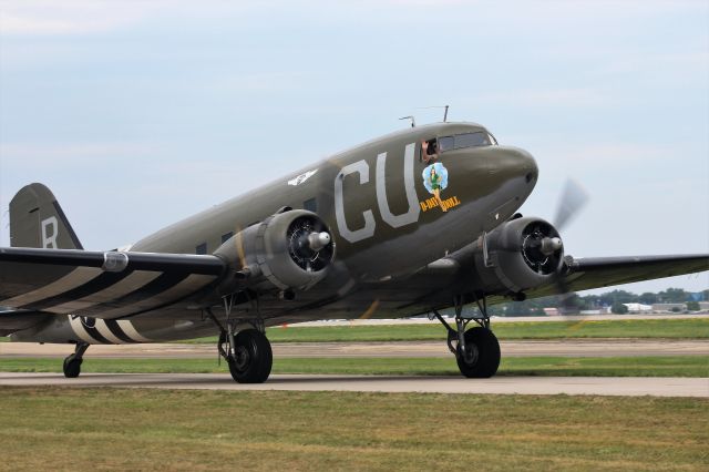 Douglas DC-3 (N45366) - The very eye pleasing D-Day Doll taxis by at Oshkosh 2019.  