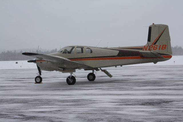 Beechcraft Twin Bonanza (N261B) - On the ramp at Saranac Lake, NY.