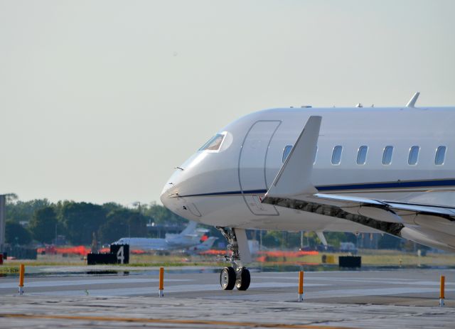 Bombardier Global Express (N302AK) - A Global 6000 taking off from Runway 34 at KPWK, taken from behind Runway 34.