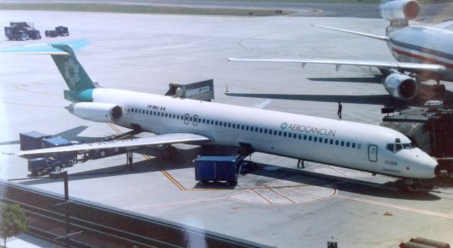 McDonnell Douglas MD-83 (VR-BMJ) - KSJC - Aero Cancun at San Jose, early 1990s - back when Terminal A had just opened - rare photo as Aero Cancun may have only worked Charter flights here maybe 4-5 times was all I ever heard. Note the AA DC-10 on Gate A-2 and the view from here was great until SJC officials built the new Intl Terminal where the Aero Cancun shows in this photo, ruining a great view area. Im unsure on the DC-10 if this was the Narita flight, if so, early 1990s pic before AA moved the gate to the north end for Tokyo arrivals and departures. First Flight 9/14/89 F-ODTN. Not my best scan