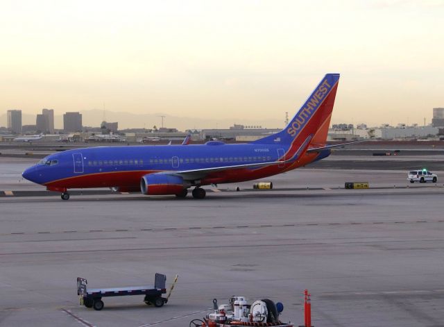 Boeing 737-700 (N700GS) - KPHX - Southwest 737-7 Line 4 on taxi for the south complex at Phoenix. Waiting for my American -800 for the ride towards home to  SMF. Dec 2017.