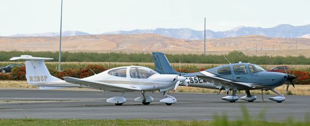 Diamond Star (N298P) - A Santa Monica based Diamond Star (N298P) parked on the Harris Ranch Airport ramp with traffic whizzing by on I-5 in the distance.