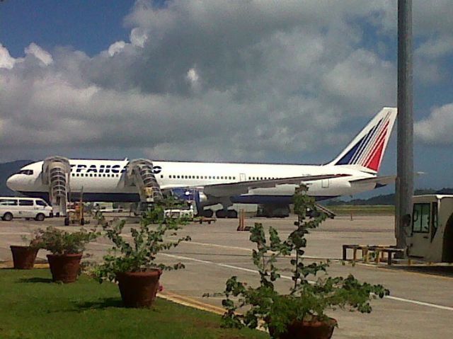 — — - This Transaero 767 flight sits at the Pte. Larue International Airport on Mahe island in the Seychelles.  Transaero operates a seasonal flight from Moscow to the Seychelles.  I took this at the Air Seychelles FBO area the airlines new VIP service building with of course my trusty Blackberry.  Skies were clear and sunny with this flight leaving on time an hour later bound for Moscow.