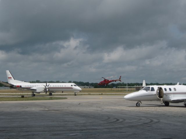 Bell 430 (N5RH) - Hendricks Motorsports 5RH taking off into the clouds. Also pictured is 511RH Saab 2000, and 55WL, a Citation.