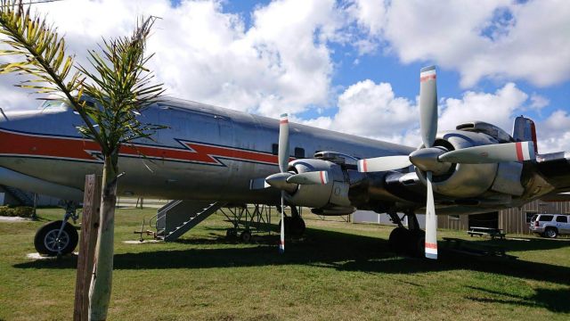 Douglas DC-7 (N381AA) - A classic DC-7 resting among some palm trees in New Smyrna, FL.