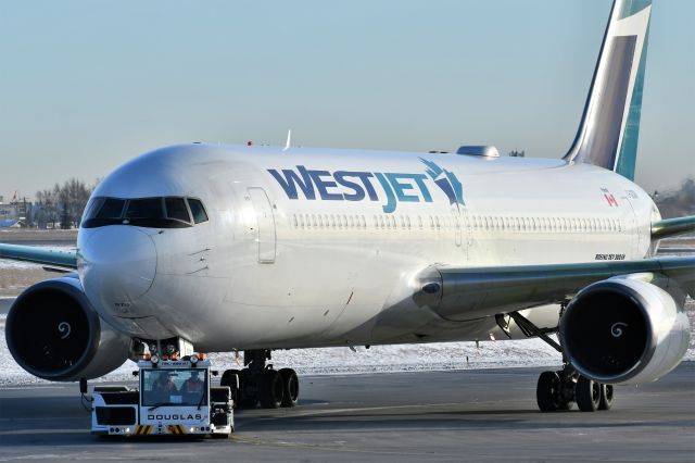 BOEING 767-300 (C-GOGN) - Westjet Boeing 767-338(ER) getting towed between terminals at YYC on Dec 28.