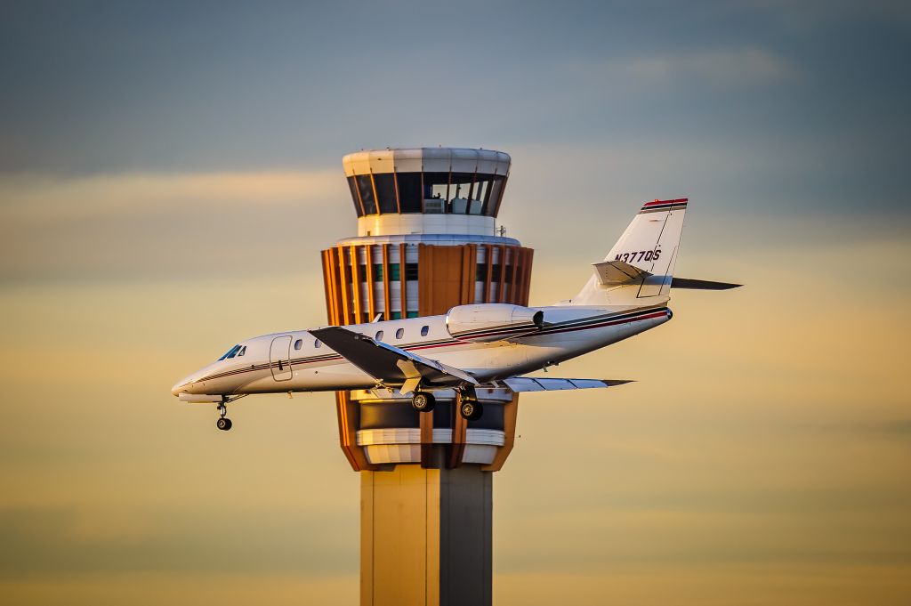 Cessna Citation Sovereign (N377QS) - A NetJets Cessna Citation Sovereign descends past the tower to Runway 25L at Phoenixs Sky Harbor International Airport.br /br /© Bo Ryan Photography 