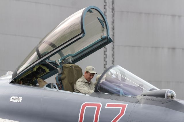 — — - Ground crew prep a Sukhoi SU-27, for it's aerial display at PAS 2013.