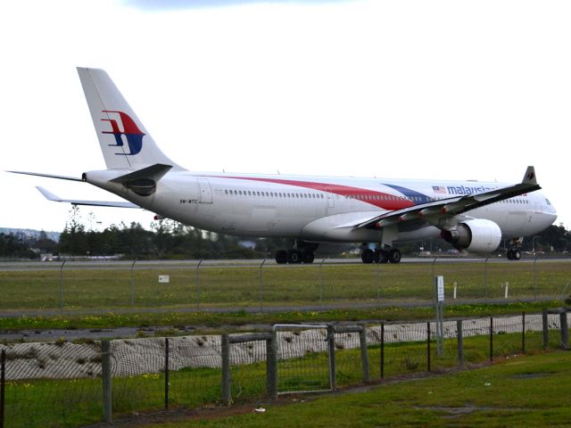 Airbus A330-300 (9M-MTC) - On taxi-way heading for take off on runway 05, for flight home to Kuala Lumpur, just before the arrival of a rain storm. Thursday 12th July 2012.