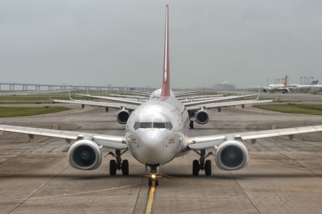 Boeing 737-800 (HL8052) - 18th August, 2019: Afternoon traffic jam at the departure runway with the pack being led by Easter Jet's Boeing 737-800 (HL8052) bound for Incheon.  How many planes can you see immediately behind it?