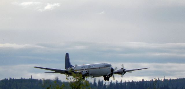 Douglas DC-6 — - Tucking in the gear as we build up speed