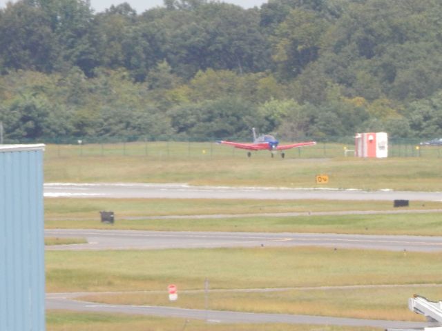 Piper Cherokee (N67WA) - A red and blue Cessna on short final to Albany.