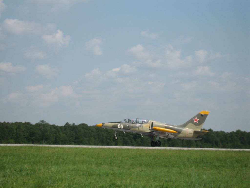 — — - L-39 taking off International Jets.