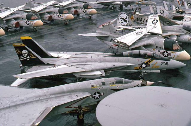 AZY206 — - "Transit tiedown" from the center island of the USS Nimitz. "Jolly Rogers" Tomcat VF-84. AJ-206 was in the movie "The Final Countdown" released in 1980 in many of the aerial scenes. RA-5C Vigilante “Vigie” of RVAH-6 in the foreground. Partial squadron of S-3A Vikings from VS-24 in the back. Top of the APS-125 Radome of an E-2B Hawkeye.  A-6 Intruder and H-3 Helo in the background. Alpha Juliet was Carrier (CVW) Air Wing 8's call on ""Uncle Chesters" ship. CVW-8 was based out of NAS Oceana in Norfolk, Va and the USS Nimitz was based at NOB (Naval Operations Base) Norfolk, Va. at the time.