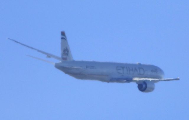 BOEING 777-300ER (A6-ETN) - Well bad sun angle, max zoom, atmosphere,  but thats ok.  Its certainly identified. Shown here is a Etihad Airways Boeing 777 a few minutes until landing in the sun or shade in the Spring of 2017.