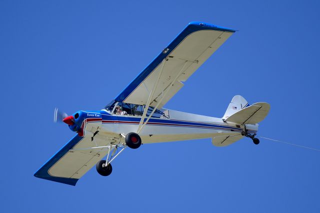 Piper L-21 Super Cub (N796AB) - Preparing to drop a banner after a two