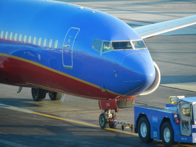 Boeing 737-700 (N256WN) - N256WN, A Southwest Airlines Boeing B737-7H4, Is Being Pushed To The Gate With A Pushback Truck, The Engines Were Not On, And The Pushback Truck Pulled Her To The Gate, N256WN Was Made In 2006