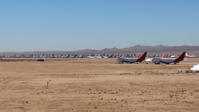 — — - November 25, 2014: An overview of "Qantas Corner" and the main storage area at Victoville. A trip here is highly recommended, and a shot like this is easily accessible due to a large dirt mound on the west side of the airport. As of March 2016, "Qantas Corner" has had most of its Qantas residents replaced by other airlines and the storage area probably looks somewhat different, with more 777 and A340 tails present.