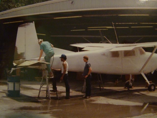 Cessna Skywagon 180 (N2517K) - Thats 17K 18o removed from straight floats and put on wheels also getting a new paint job. The guy in the surgical suit painting is Mr. Kirby Gaspard the Black guy is really only known as Dancer and Me. Picture taken by my Dad in front of Westwegos Maint. hangar at Westwego Airport.