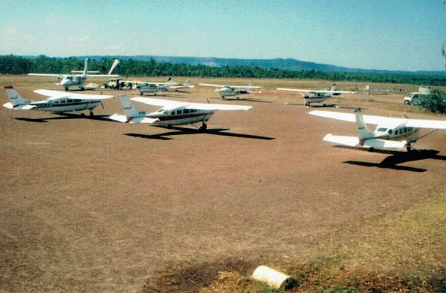 — — - A busy afternoon at Jabiru in 1989, Northern Territory Aeromedical Nomad N24, in the background and Kakadu Airs C207s in the foreground.