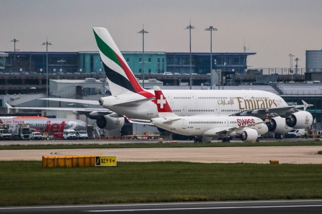 Airbus A220-300 (HB-JCM) - Siblings.  SWR390 arriving from Zurich passing big sister A6-EOR