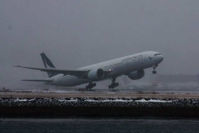 BOEING 777-300ER (B-KPM) - Cathay Pacific departing a snowy/foggy Boston Logan Airport, normally not seen in daylight hours, the flight was operated w/delays due to a Noreaster. 