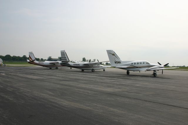 Cessna 421 (N5NN) - N5NN on the far right parked next to two Aero Commanders