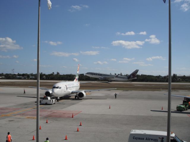 Airbus A330-200 (A7-HJJ) - Leaving Grand Cayman, with VP- CKY in front