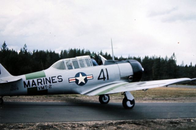 — — - I have no information on this airplane, I guess it must have been a Harvard of some variation. At this point even though the photo looks old I believe the aircraft had been restored, it was immaculate as I recall. Maybe someone has info and can comment? I shot this in approximately 1981 on slide film at an airshow. This is merely a DSLR photo of an Echtacrome slide I processed myself roughly 35 years ago when I was probably still in High School. The airport was last known as 21D4, "Silverwood" on the northern outskirts of Coeur d Alene Idaho (KCOE). At the time this shot was taken I believe it was known as Henley Aerodrome. There is no longer an airport there, its an amusement park now.