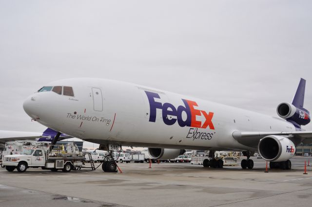 Boeing MD-11 (N585FE) - Against a grey sky this 3 hole jumbo is resting in South Cargo waiting for the next call