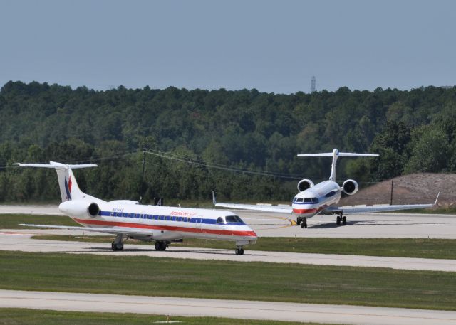 Embraer ERJ-135 (N834AE) - 2 American Eagles planes at KRDU.  N834AE taxiing and N521AE just landed and turning off RWU 5L