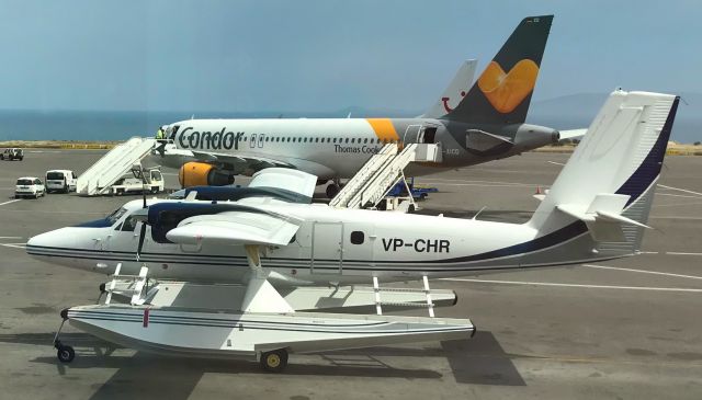 Beechcraft 19 Sport (VP-CHR) - Seaplane with wheels, DeHavilland DHC6-400 Twin Otter on Herkalion Airport, Crete, Greece,  in the back Airbus A320-212 D-AICD from German Condor, operating holidaycharter flights. Seen from departure hall gate A6