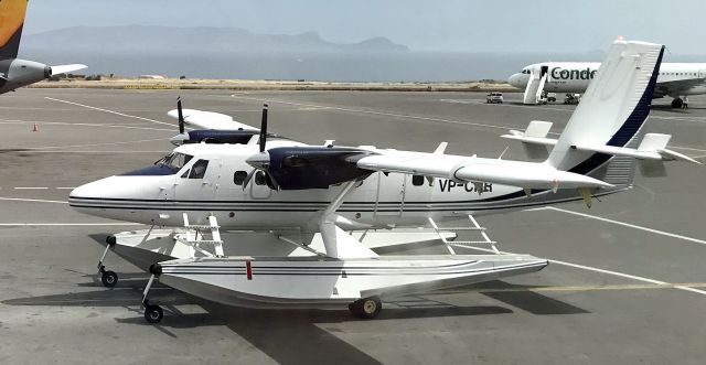 Beechcraft 19 Sport (VP-CHR) - Seaplane with wheels, DeHavilland DHC6-400 Twin Otter on Herkalion Airport, Crete, Greece,  in the back Airbus A320-212 D-AICD from German Condor, operating holidaycharter flights. Seen from departure hall gate A6