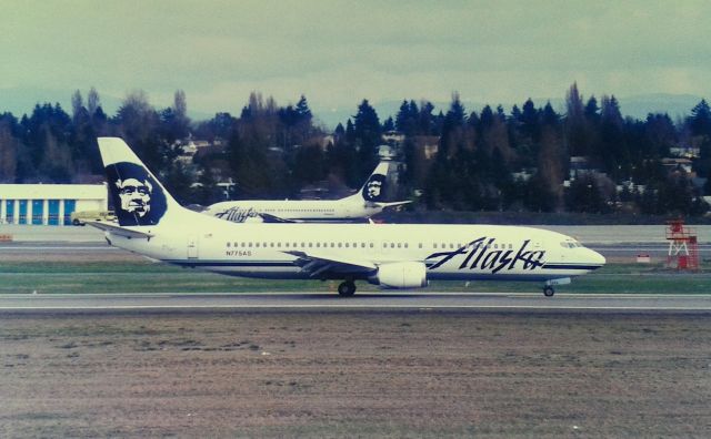 BOEING 737-400 (N775AS) - KSEA - Alaska 737-4 landing then 16R on a typical cloudy day in the PNW. Photo from the now closed Airpark at Seattle. CN 25108 LN 2551 delv new March 12th, 1993 - photo date Feb 27th, 1995. photo scan.