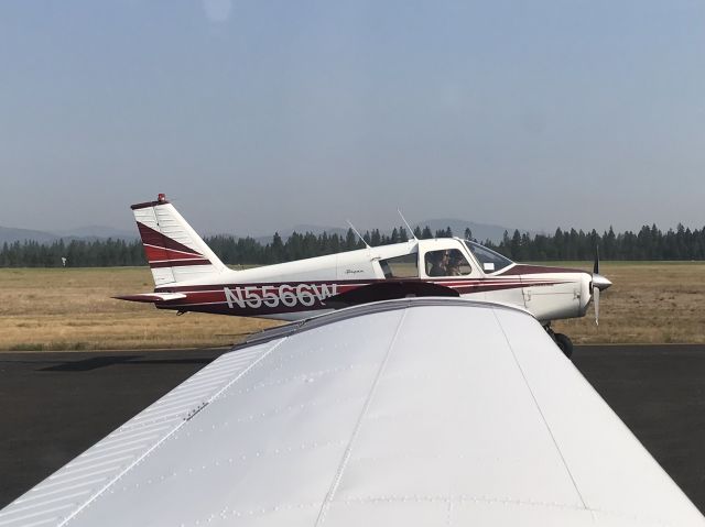 Piper Cherokee (N5566W) - Piper Cherokee off my left wing during runup, August 8th 2019. Records show this aircraft later crashed somewhere in California. 