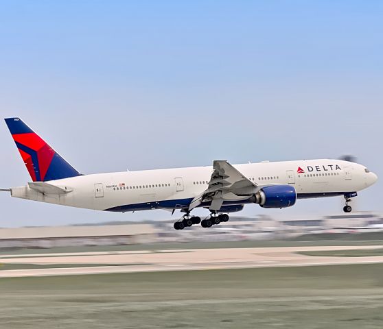 Boeing 777-200 (N860DA) - Delta 777 speeding past the tower on the 22R approach. Came in as a reposition flight to get re-retrofitted with seats after doing cargo only runs between Chicago and Frankfurt. Later went to charter for the Indiana Colts.br /br /9/2/2020