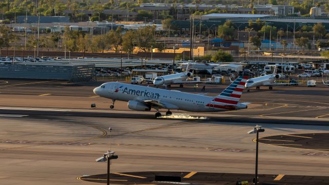 Airbus A320 (N653AW) - American Airlines A320 landing at PHX on 7/7/22. Taken with a Canon 850D and Rokinon 135mm f/2 lens.