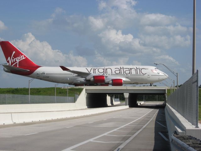 Boeing 747-400 (G-VTOP) - Virgin Atlantic taxi over bridge at Orlando Airport.