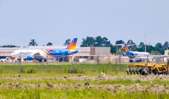 Airbus A320 (N258NV) - View of the ramp from across the field.  Significant because this could be one of the last visits for an Allegiant MD-80 at Punta Gorda!br /Taken 6/21/18