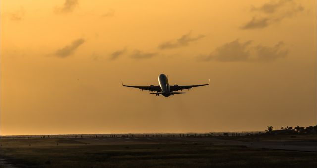 Boeing 737-700 (N818NN) - American Airlines seen departing St Maarten for Miami and sunset.