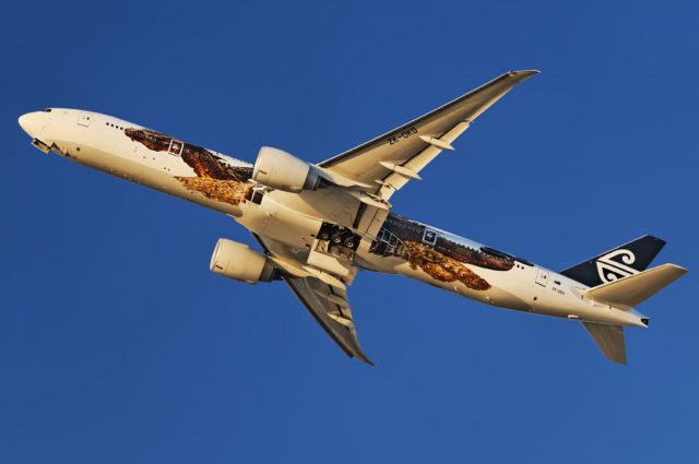 BOEING 777-300ER (ZK-OKO) - An Air New Zealand operated Boeing 777-300 series widebody jet in special, movie promotional "Hobbit – The Desolation of Smaug" livery, takes to the skies in the late afternoon, after liftoff from the Los Angeles International Airport, LAX, in Westchester, Los Angeles, California