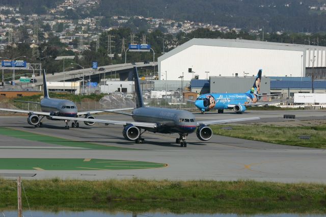 Boeing 757-200 (N550UA) - KSFO - UAL 757-200 leads A320 N855US and Alaska Airlines "Disney-jet" N784AS to Runway 1R on Apr 5th, 2005. Nice clear weather in the AM this day made for some nice departure shots.