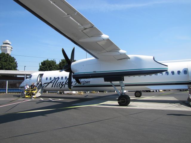 de Havilland Dash 8-400 (N444QX) - Alaska Horizon Air N444QX at the Horizon gate area at Portland Intl. Airport. The control tower is in the upper left of this photo.