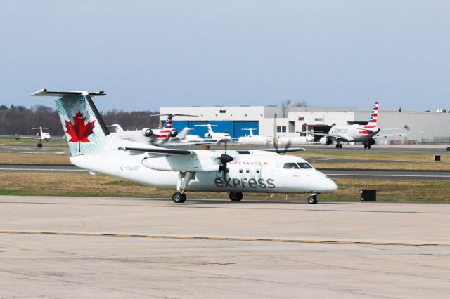 de Havilland Dash 8-100 (C-FGRP) - JZA8842 arriving from Montreal with a couple of AAL departing in the background and a busy ramp at Bombardier.