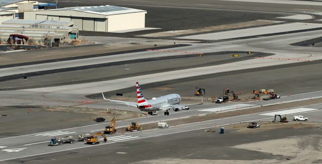 Boeing 737-800 (N973NN) - With Reno-Tahoe International's ILS runway 34L-16R, the longer (11,000+ vs 9000 feet) of RNO's parallel runways, now gutted up its center as seen here; American's B738 N973NN is clicked in this snap taken yesterday (20 Mar 2021) from the top of Rattlesnake Mountain as it covers the last three thousand feet of its shoft final to Runway 34R.