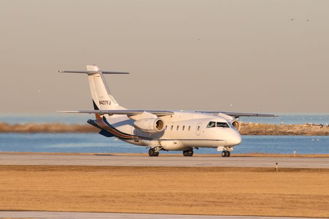 Fairchild Dornier 328JET (N407FJ) - UJC901, during an early morning departure on RWY 6L amidst a scenic Cleveland/Lake Erie backdrop. Ultimate 901 was en route to Cincinnati Muni (KLUK).